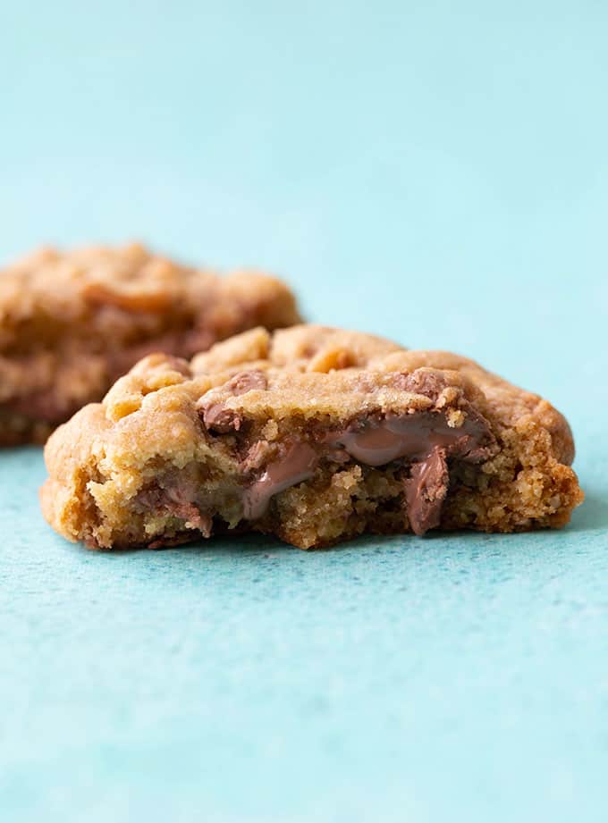 A chocolate chip cookie with chocolate oozing 