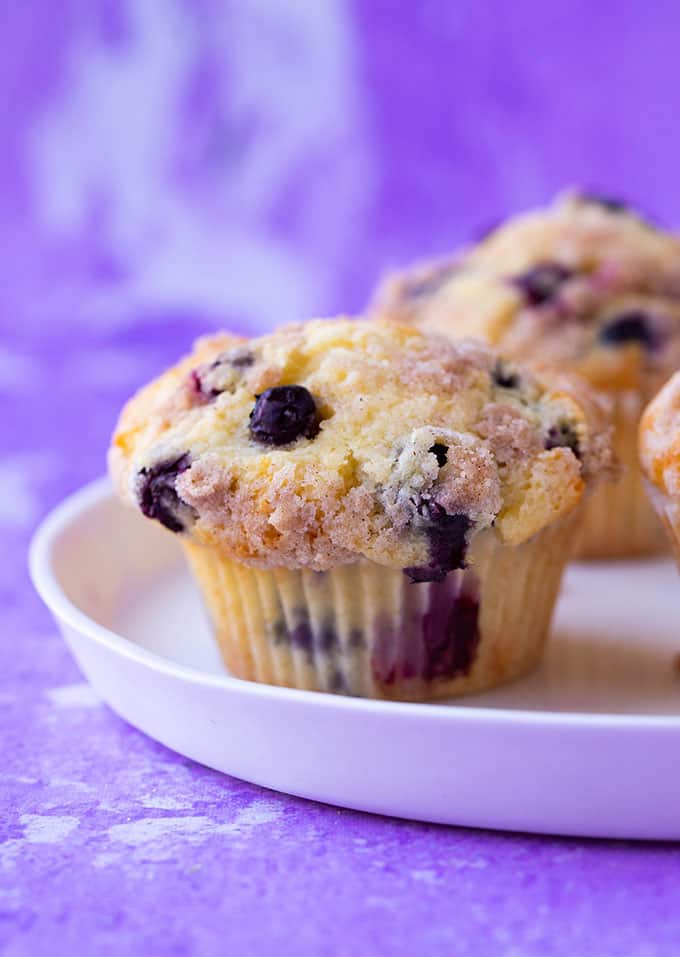 A Blueberry Crumble Muffin on a white plate
