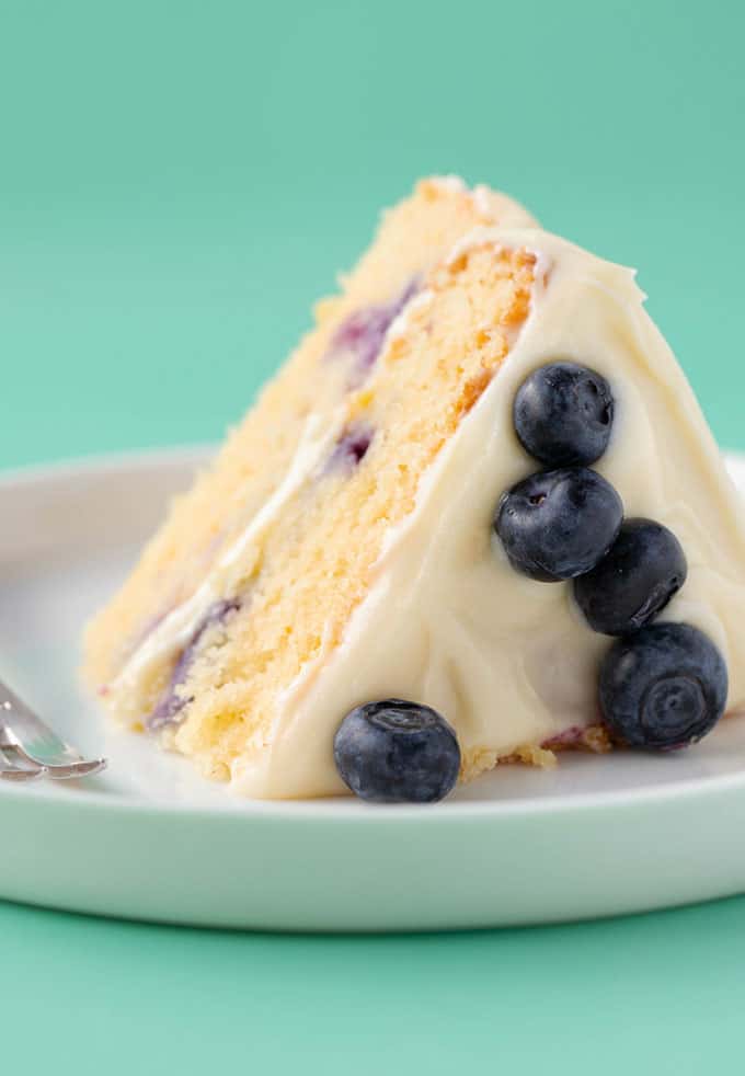 A piece of Lemon Blueberry Cake on a white plate