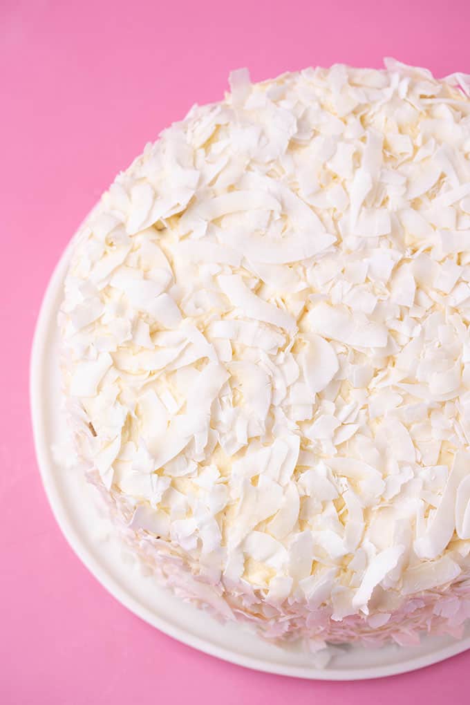 Top view of a homemade Coconut Cake covered in coconut flakes