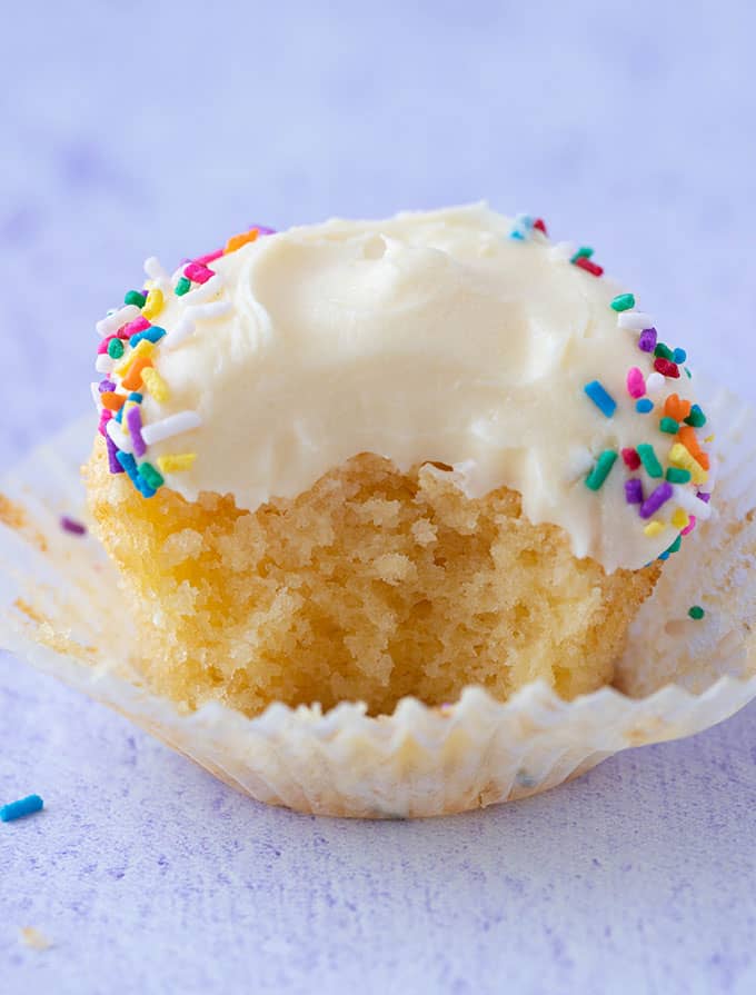 Vanilla cupcake with a bite taken out of it