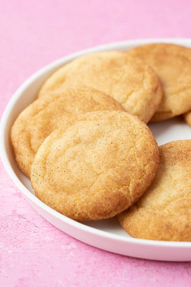 A plate of Snickerdoodle Cookies on a pink backdrop.