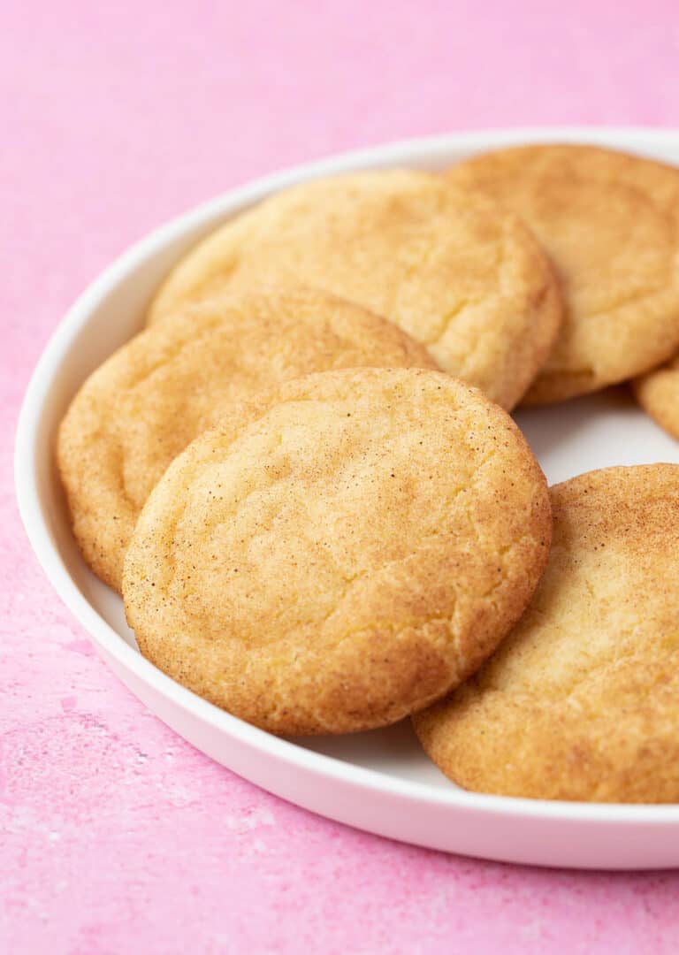 A plate of Snickerdoodle Cookies on a pink backdrop.