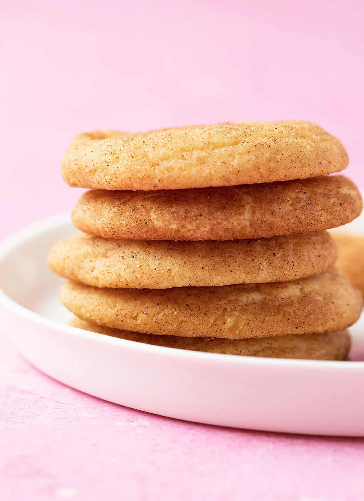 A stack of Snickerdoodles Cookies on a white plate. 