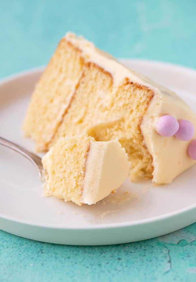 A slice of Vanilla Cake with a bite taken out of it