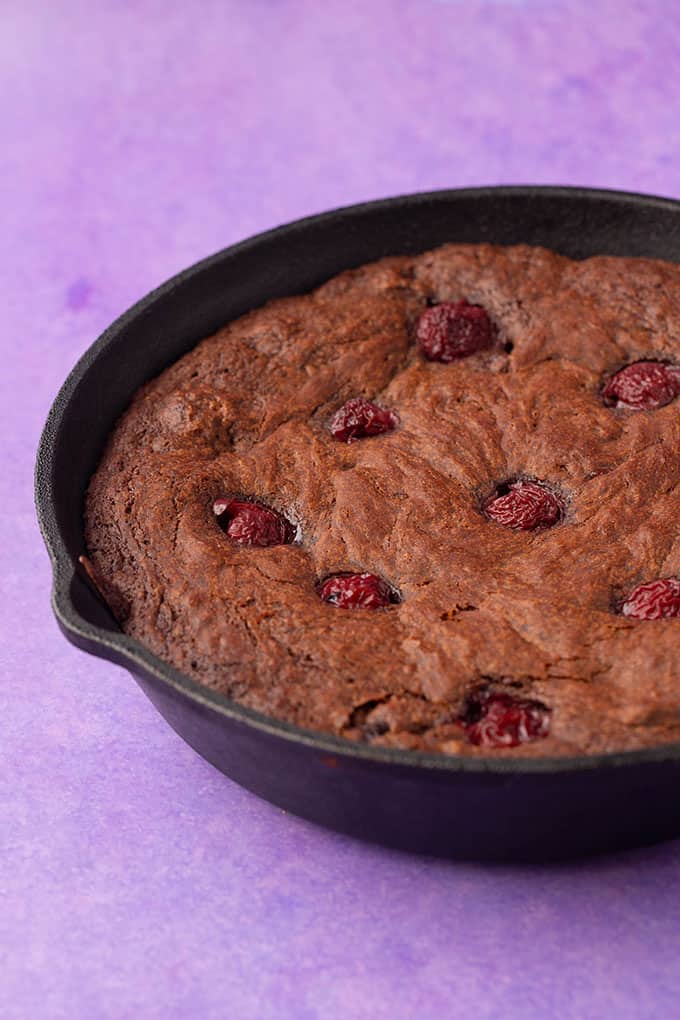 Black Forest Skillet Brownie on a purple background