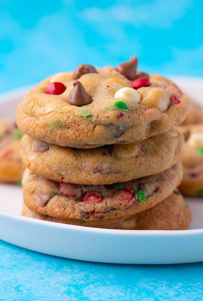 A stack of homemade Christmas Cookies on a white plate