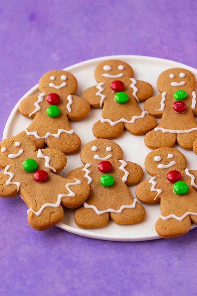 A plate of homemade Gingerbread Cookies on a purple background