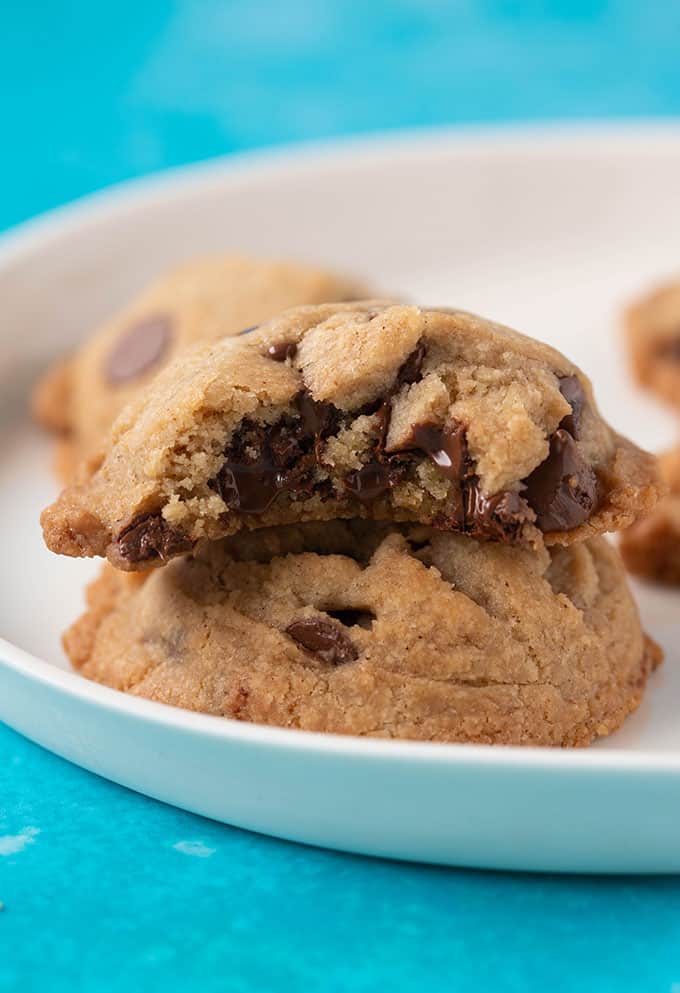 A stack of Vegan Chocolate Chip Cookies with a bite taken out of it