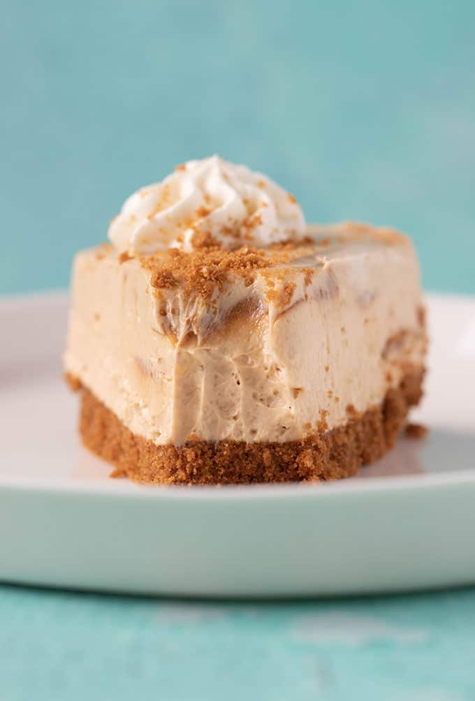 A slice of Biscoff Cheesecake with a bite taken out of it. 