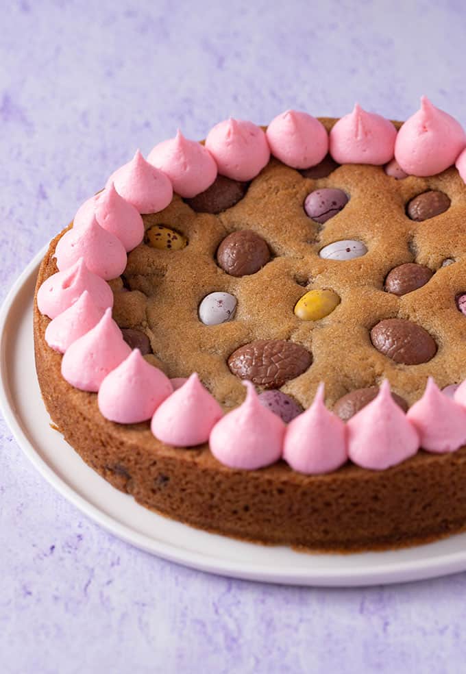 A giant Easter Egg Cookie Cake decorated with pink frosting