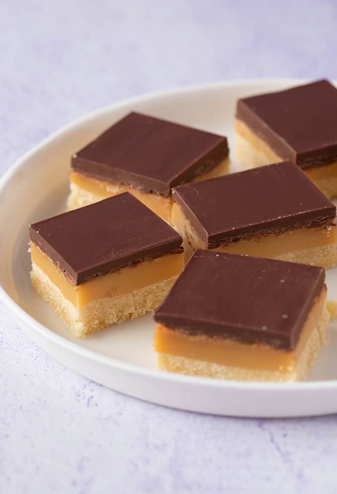 A stack of Caramel Slice pieces on a white plate