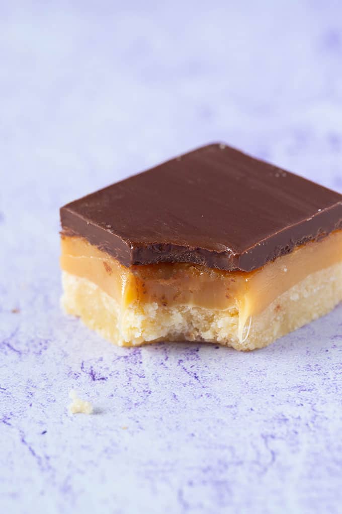Homemade Millionaire Shortbread with a bite taken out of it