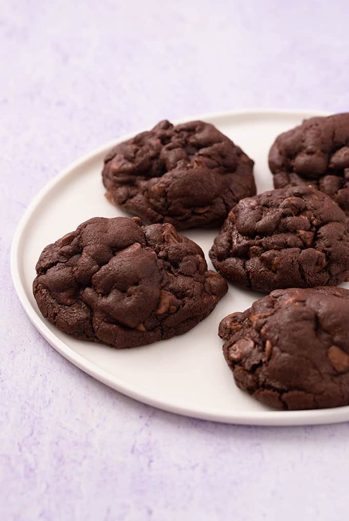 A white plate of Chocolate Cookies filled with chocolate chips
