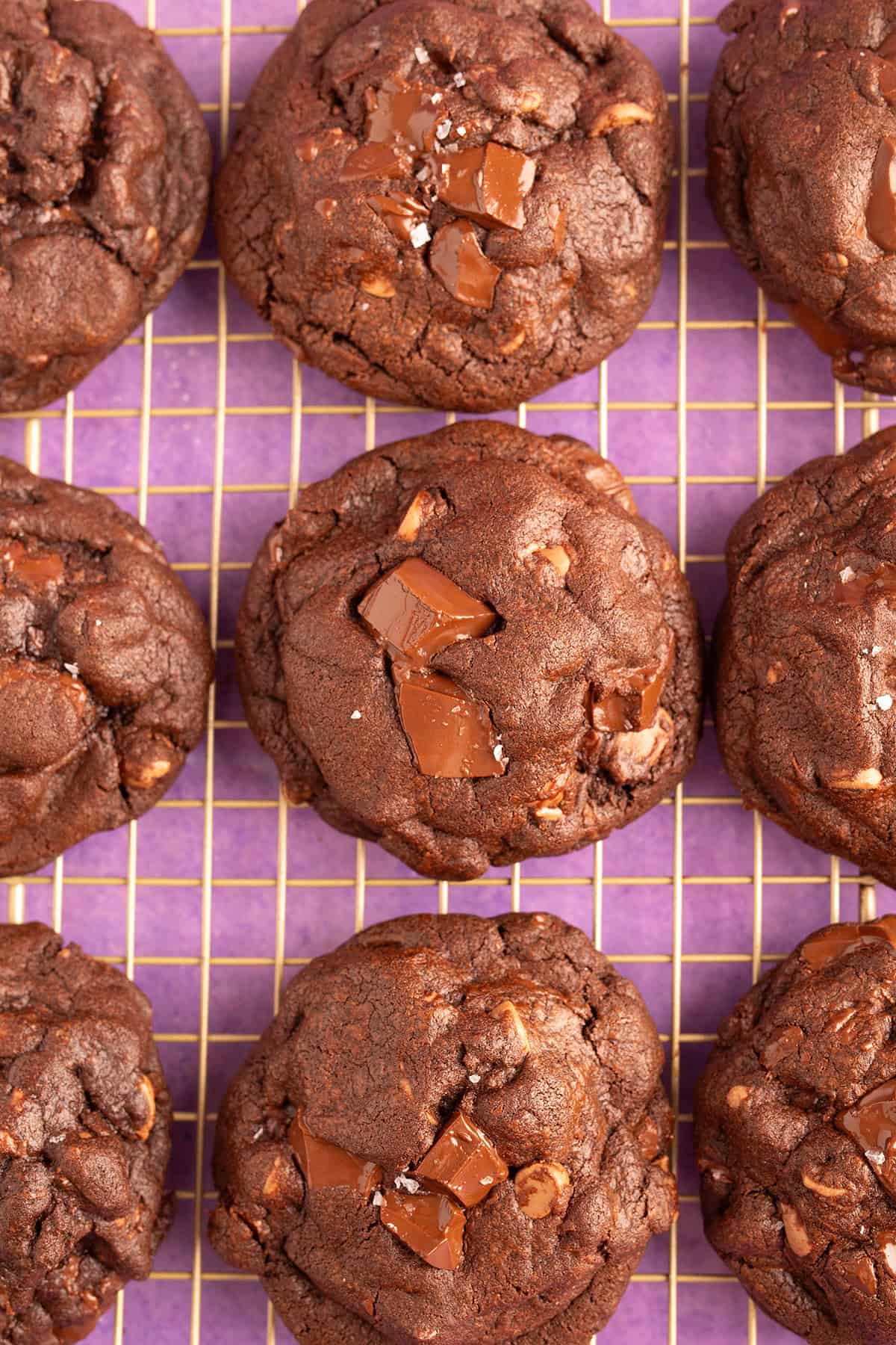 Top view of chocolate NYC cookies on a gold cooling rack.