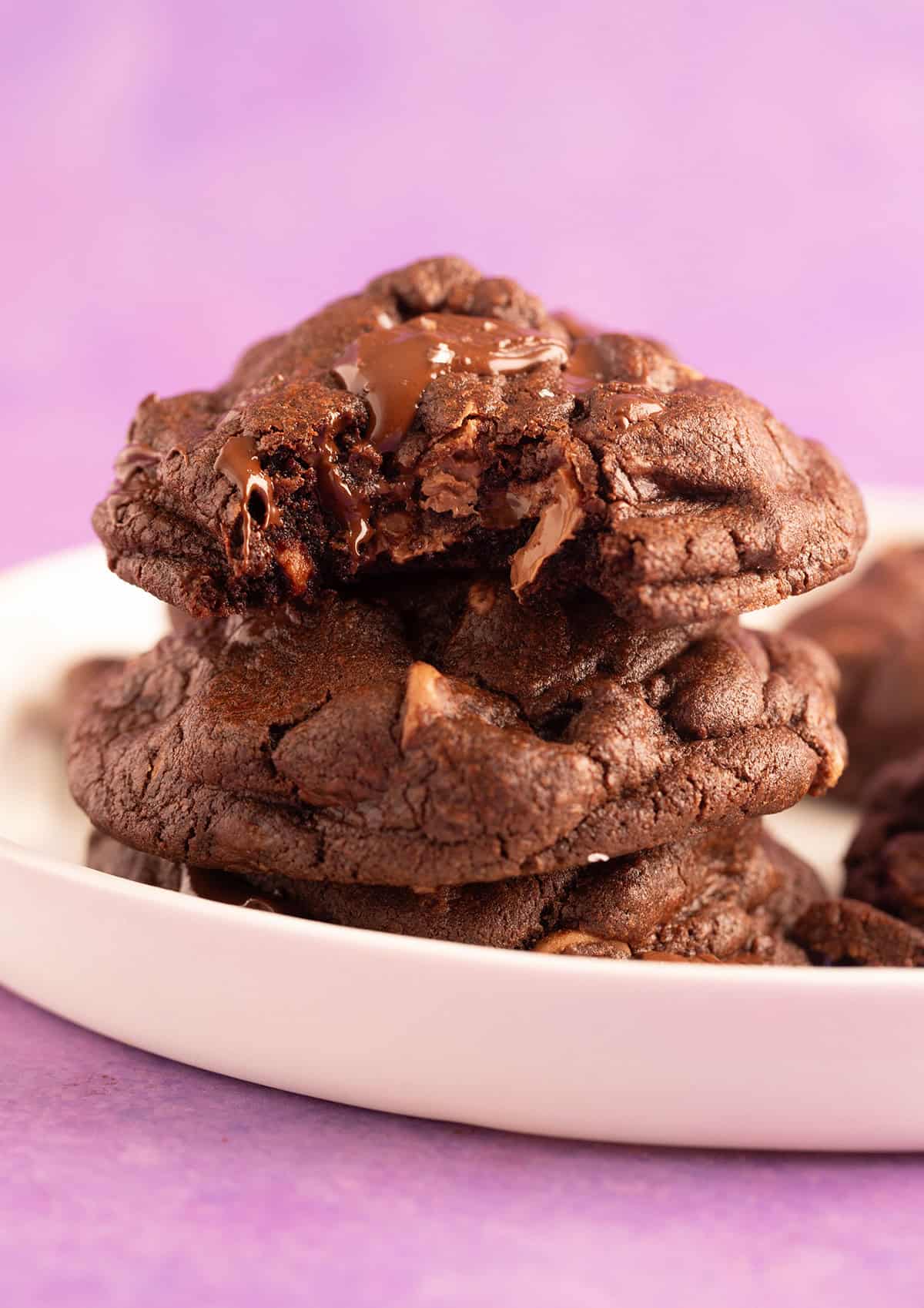A stack of chocolate cookies on a purple backdrop.