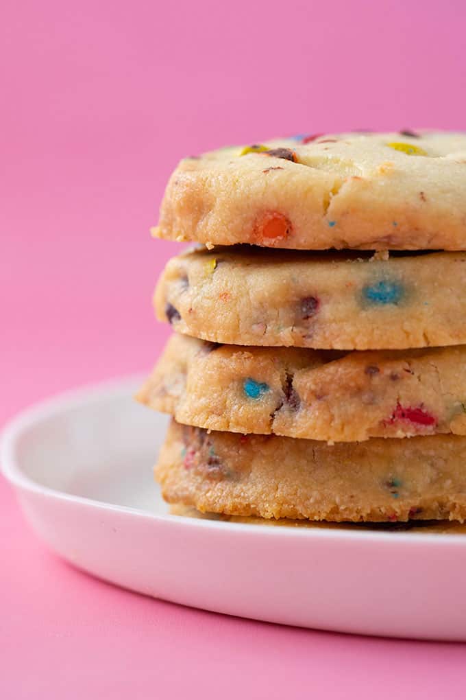 A tall stack of homemade Shortbread Cookies on a pink background