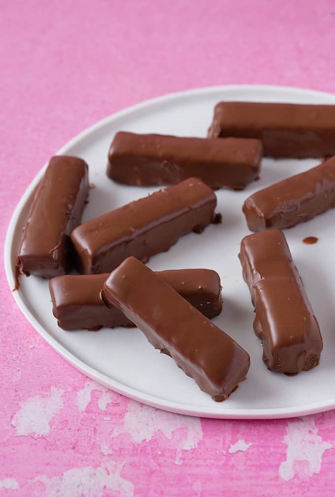 A plate of homemade chocolate covered Twix Bars.