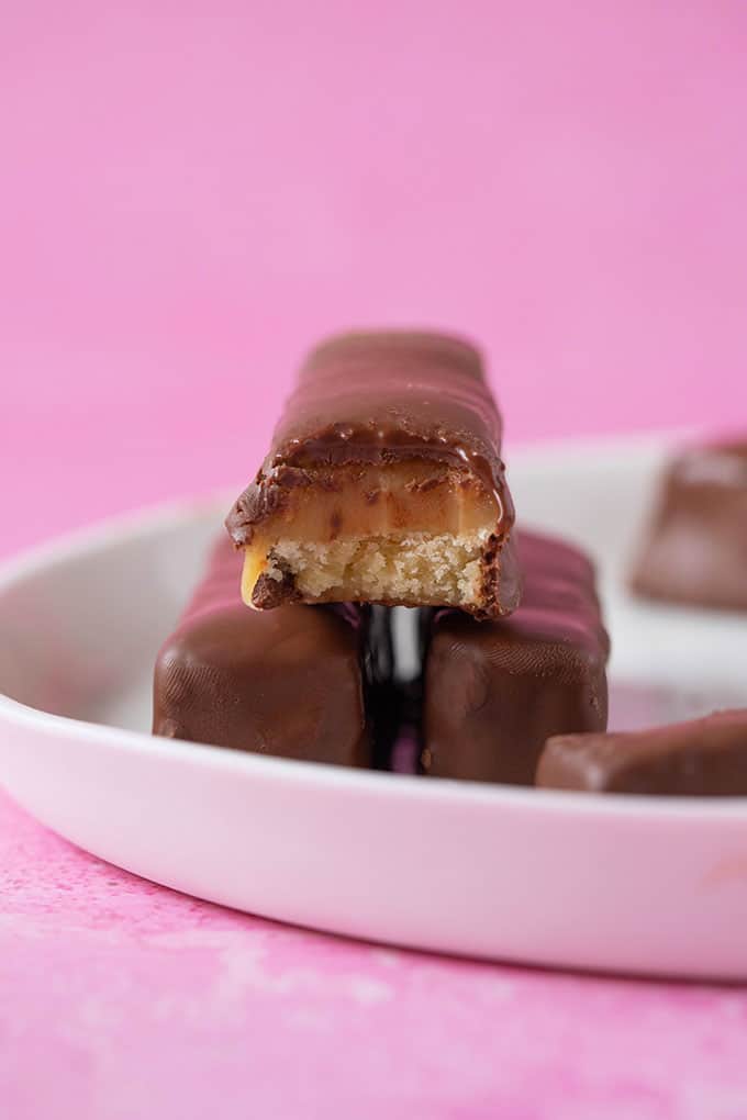 A stack of homemade Twix Bars on a white plate
