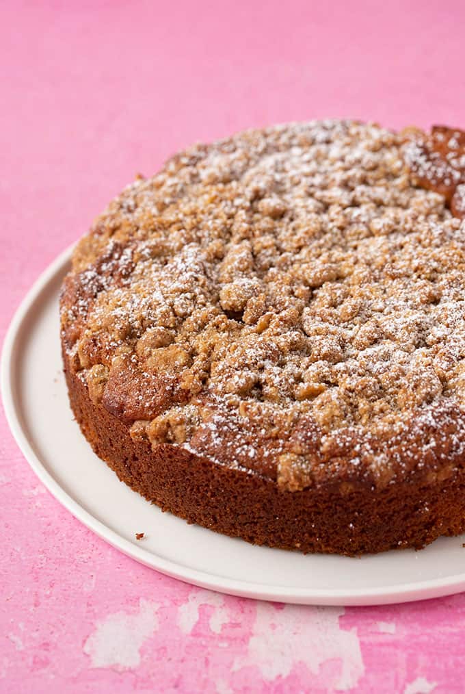 A homemade Coffee Cake topped with cinnamon crumble and dusted with icing sugar. 