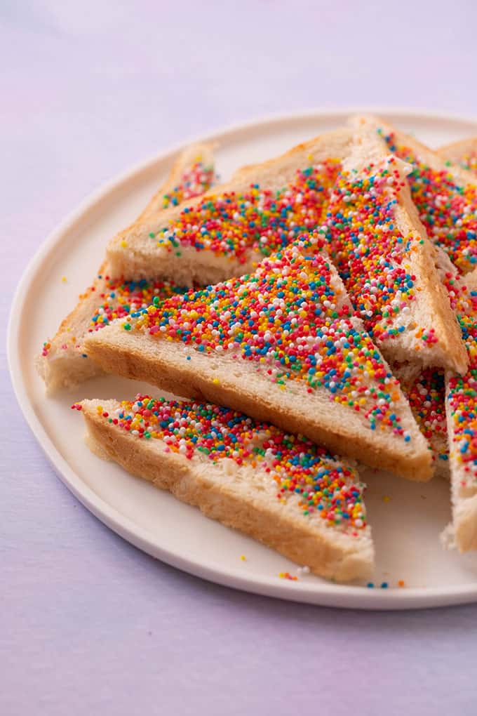 A plate of Fairy Bread on a purple background