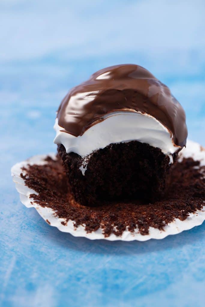 A homemade chocolate marshmallow cupcake with a bite taken out of it