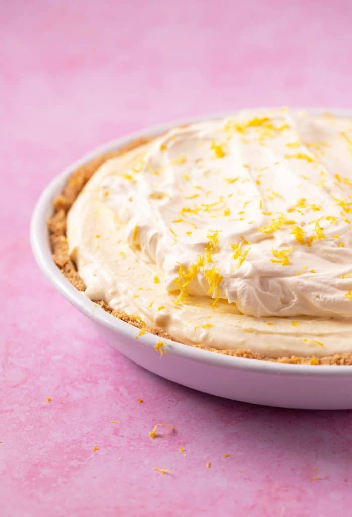 A beautiful homemade Lemon Pie on a pink background