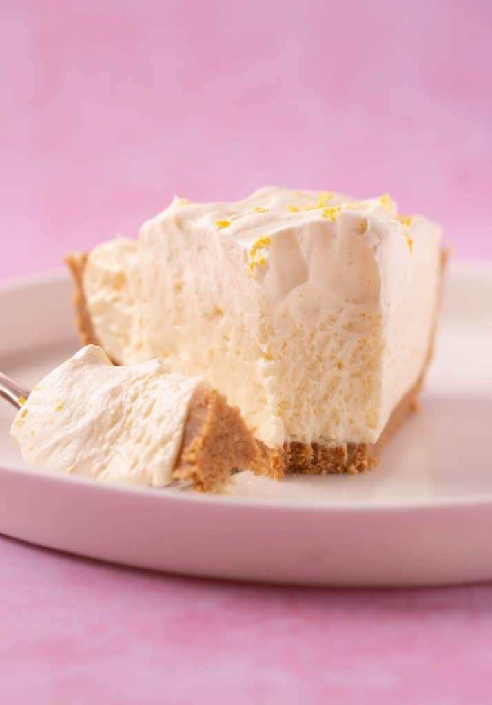 A slice of homemade Lemon Pie with a bite taken out of it