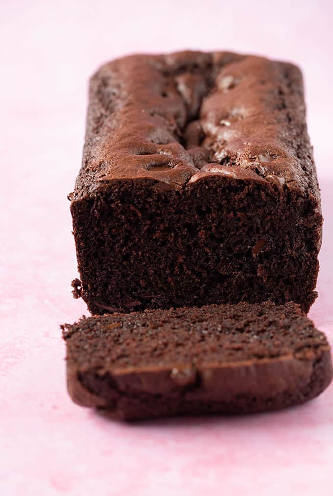 A homemade Chocolate Bread loaf on a light pink background