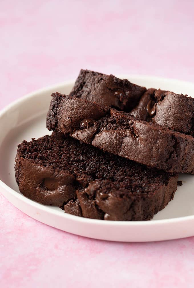 Thick cut slices of homemade Chocolate Bread on a pink background