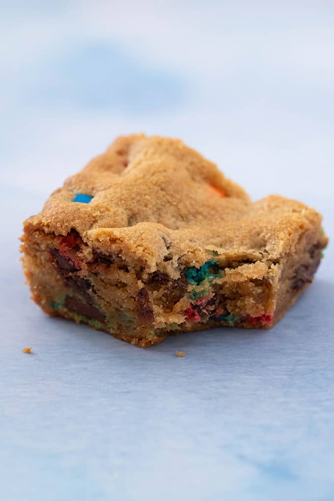 A buttery cookie bar with a bite taken out of it
