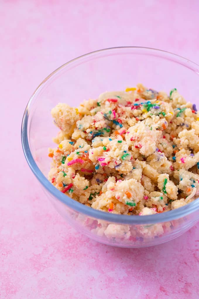 A glass bowl filled with funfetti cookie crumbs