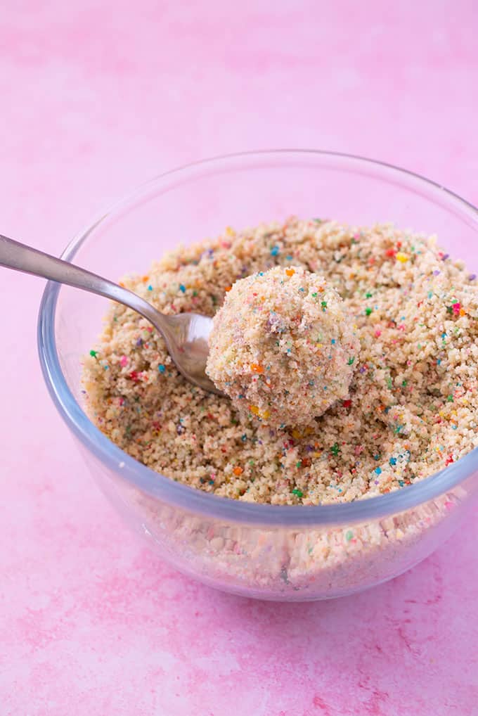 A glass bowl filled with birthday cake cookie crumbs 