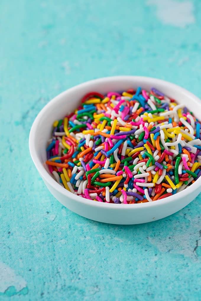 A small white bowl of funfetti sprinkles