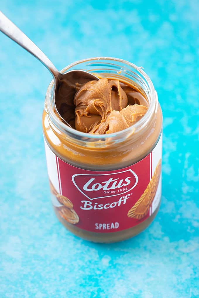 A jar of Biscoff Cookie butter on a blue background