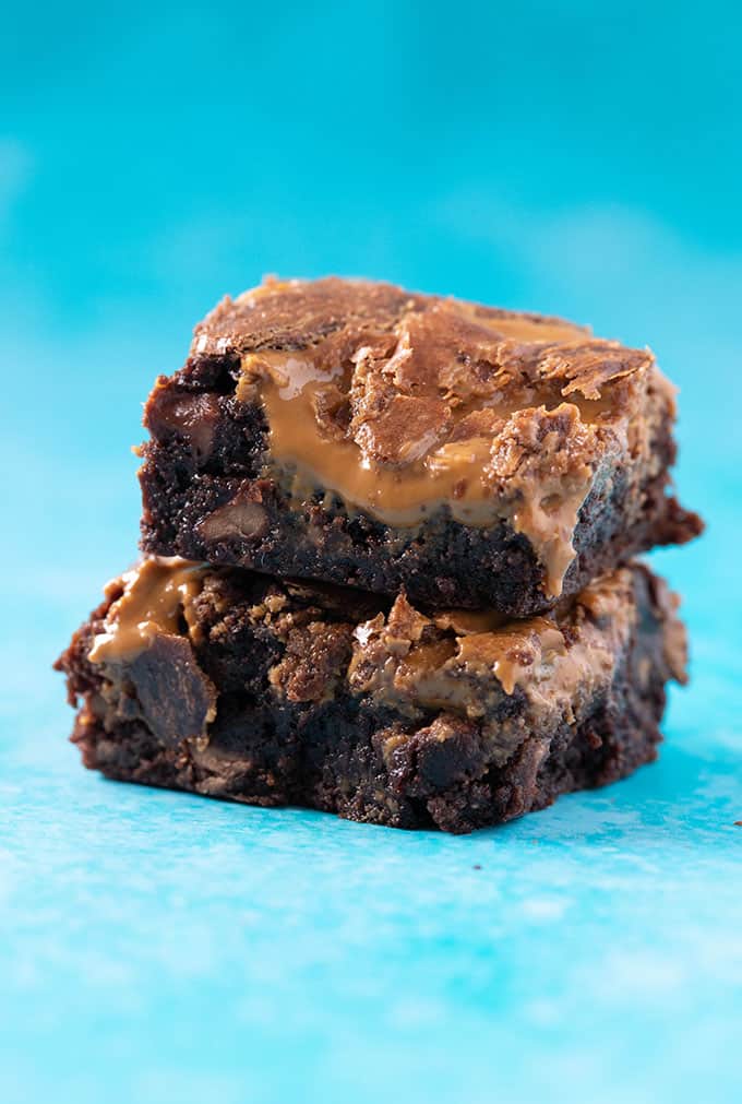 A stack of gooey Biscoff Brownies in a blue background 