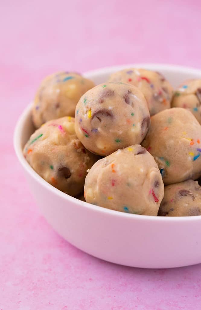A white bowl filled with homemade cookie dough balls