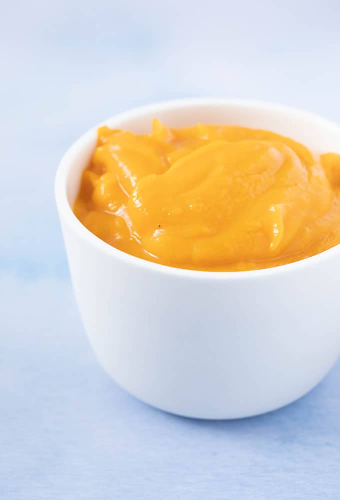 A white bowl filled with homemade pumpkin purée