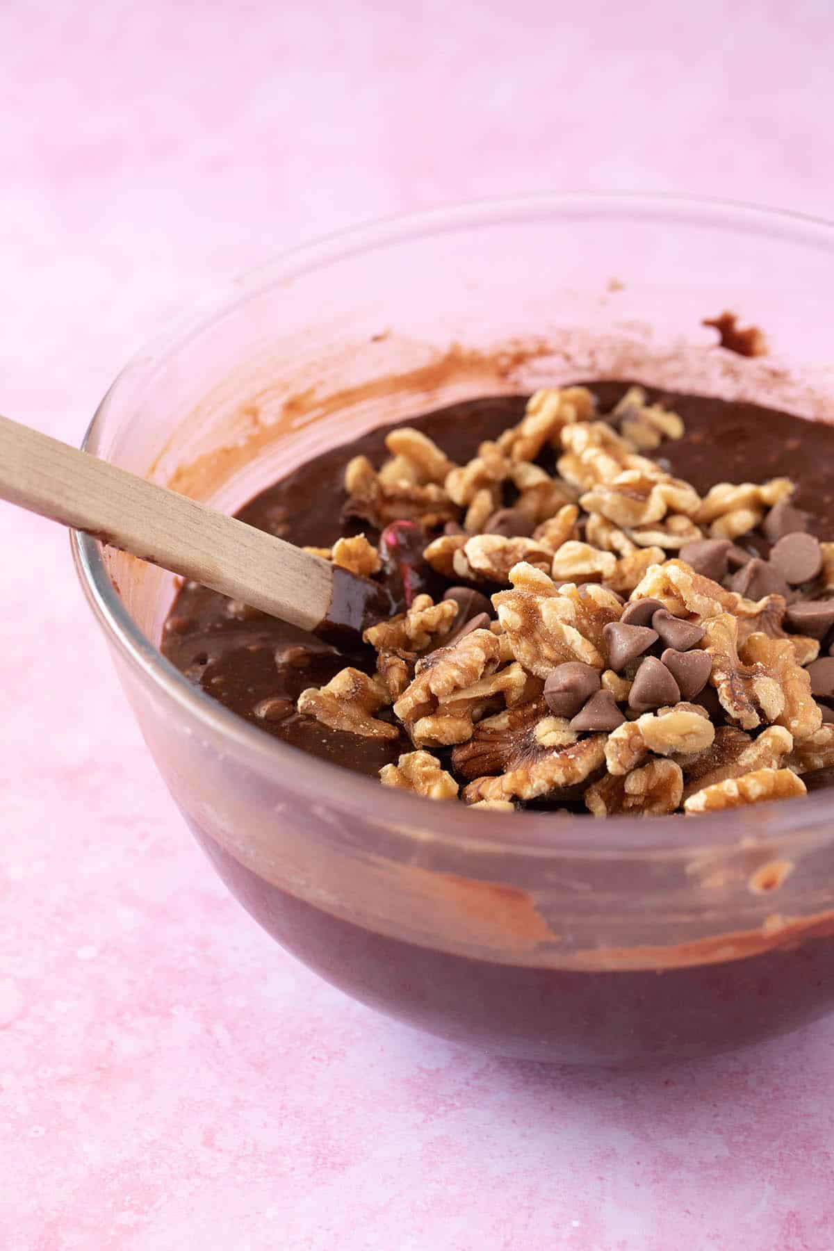 A glass bowl filled with chocolate brownie batter 