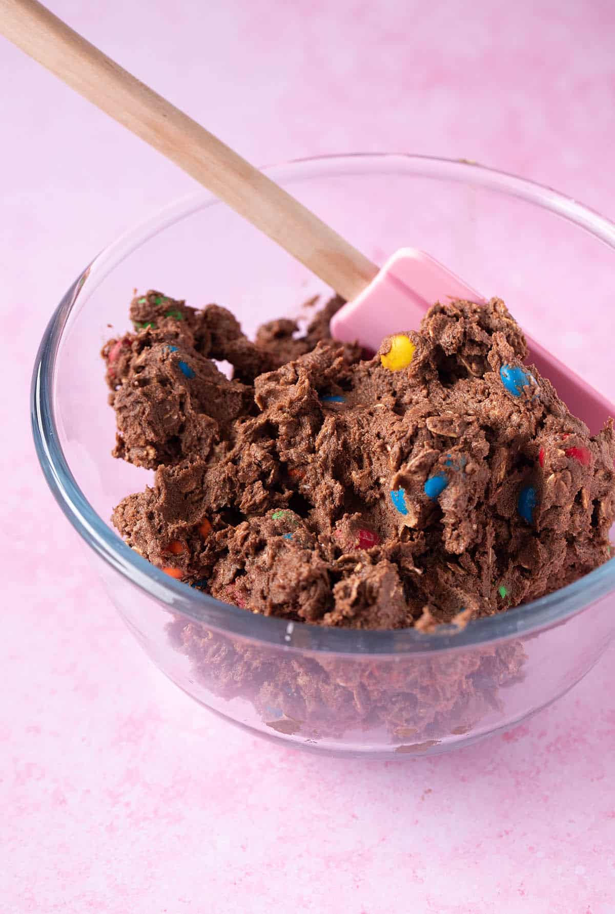 A glass bowl filled with chocolate cookie dough
