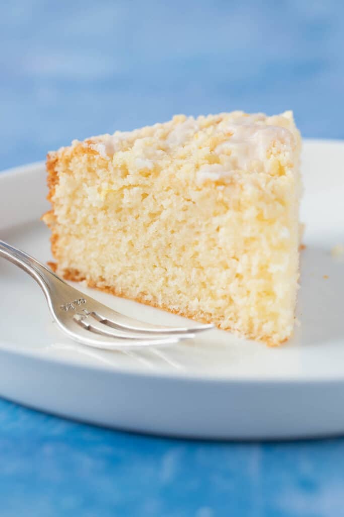 A slice of Lemon Yogurt Cake on a white plate