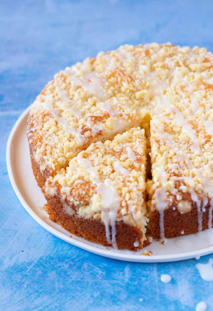 A lemon crumb cake with a slice taken out of it