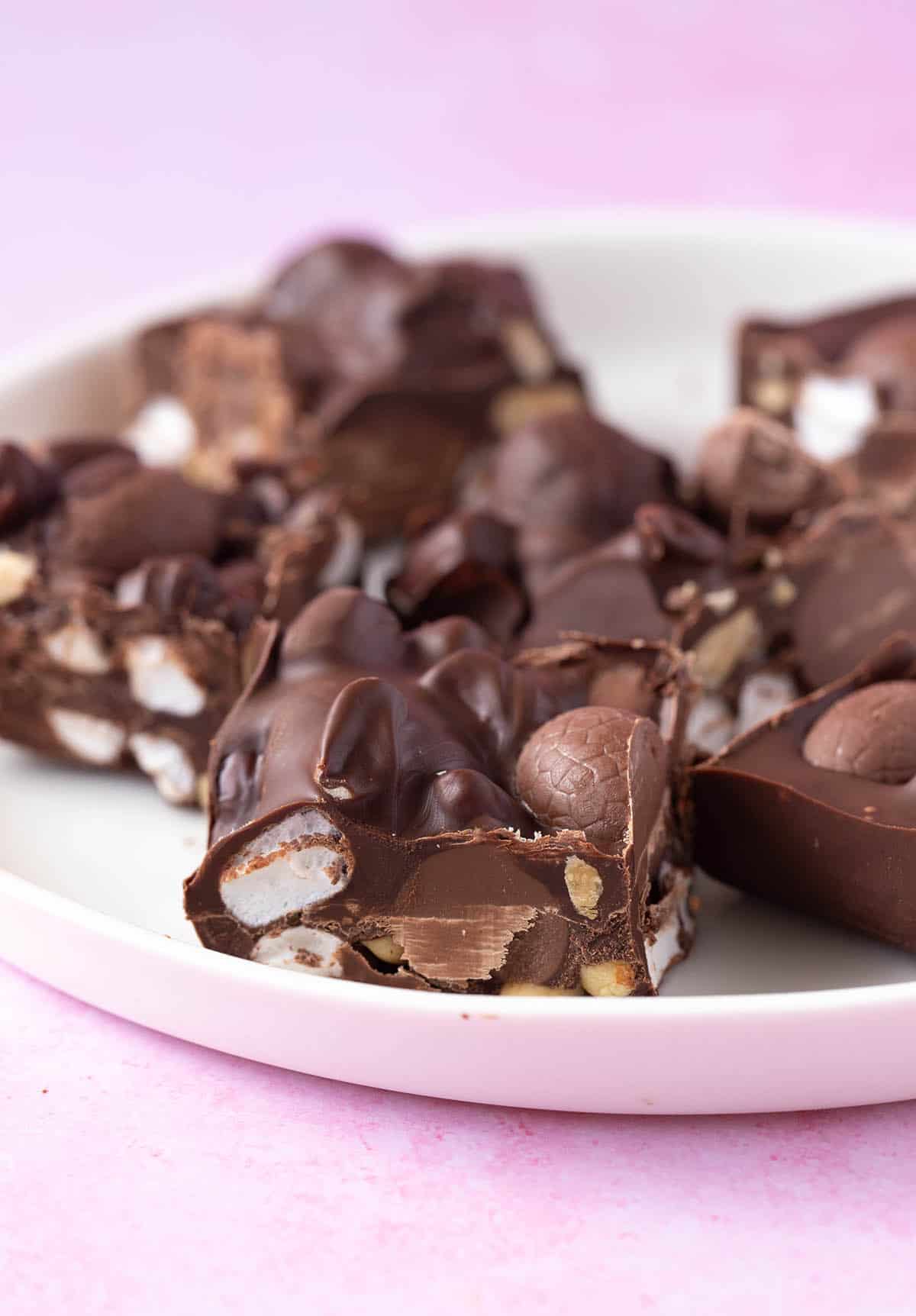A plate of Easter egg rocky road on a pink background.