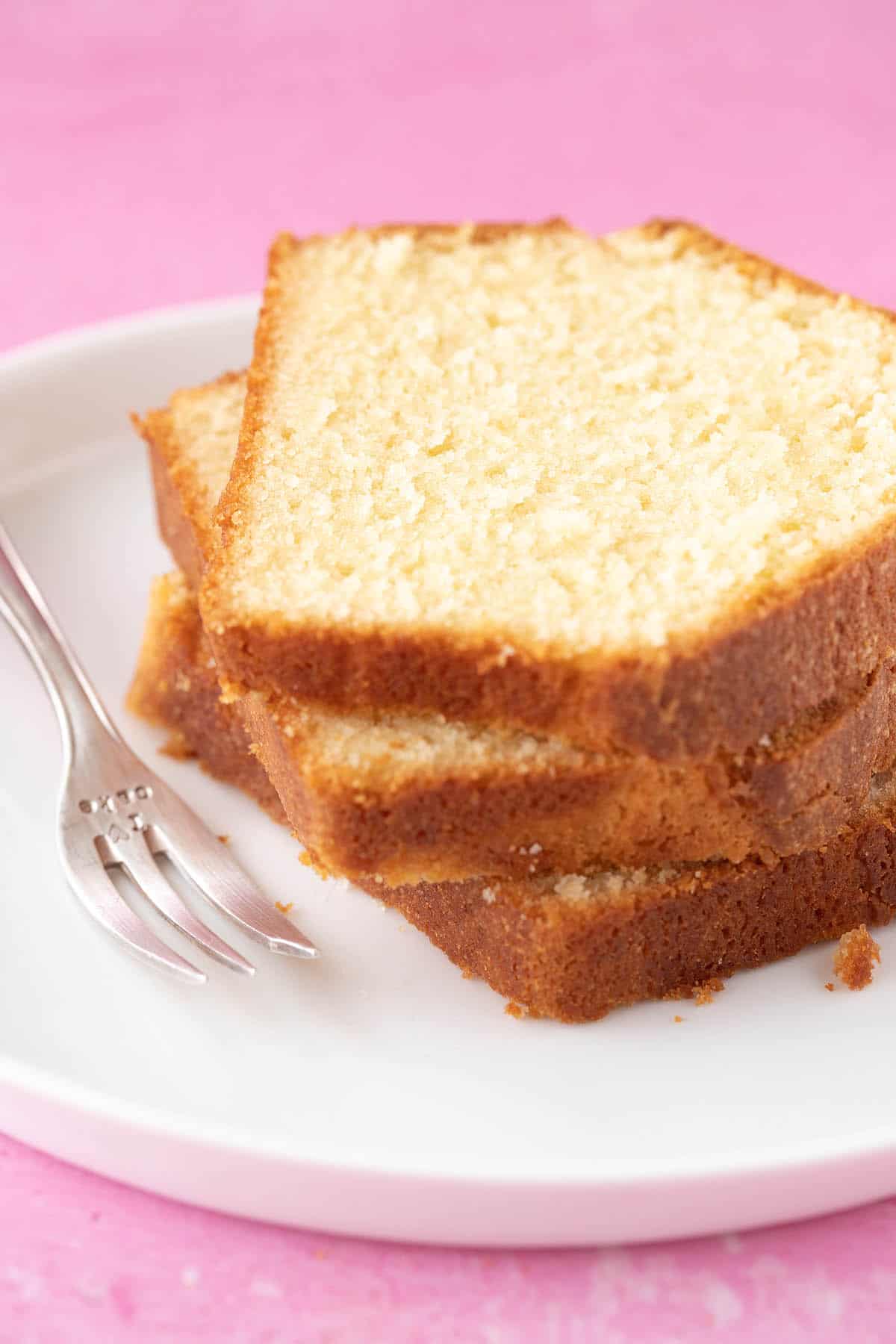 A stack of Pound Cake slices on a white plate