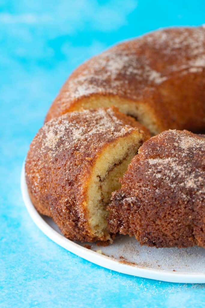 A beautiful cinnamon Bundt cake with a slice cut out of it