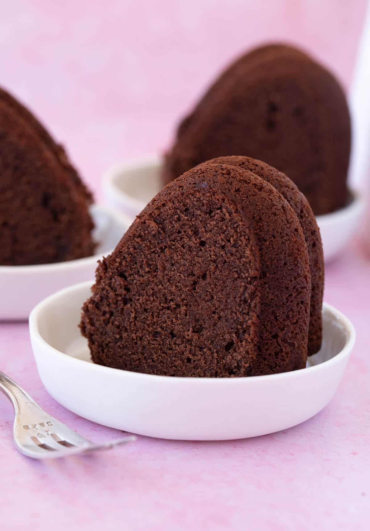 Slices of Chocolate Pound Cake on a pink background