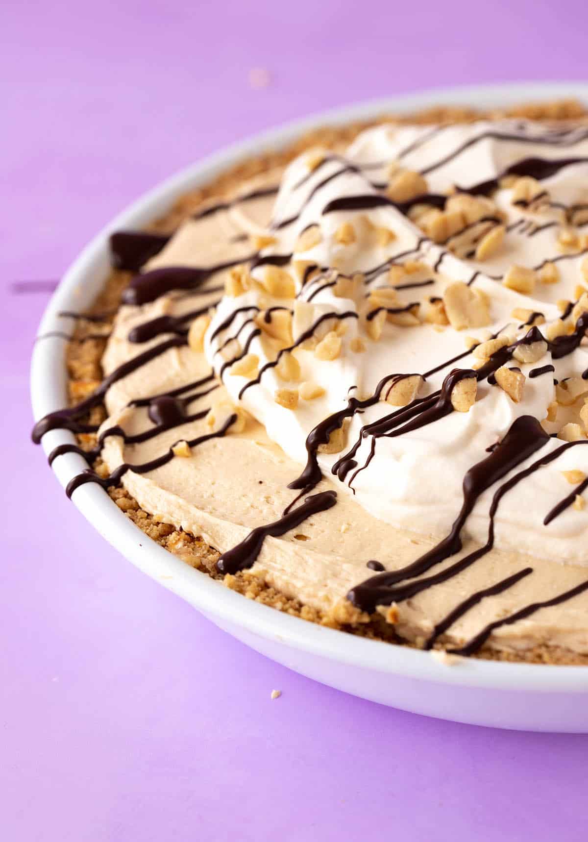 A beautiful Peanut Butter Pie topped with whipped cream.