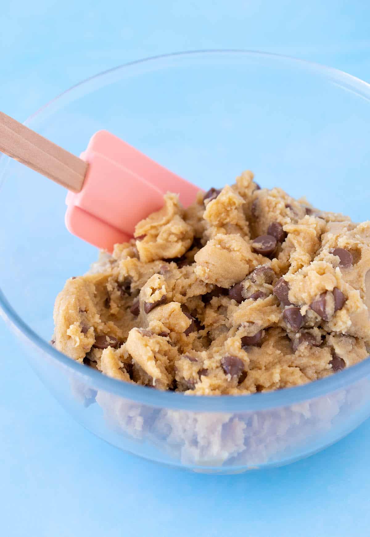 A glass bowl of chocolate chip cookie dough