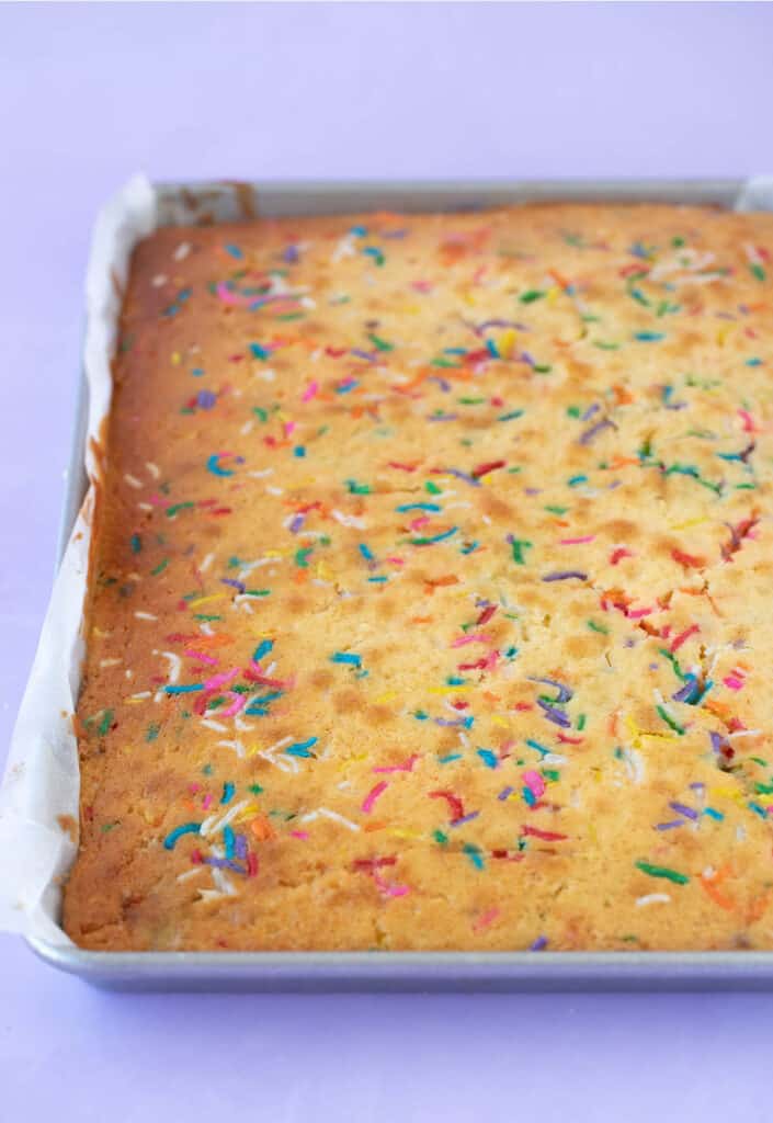 A Funfetti Cake baked in a quarter sheet pan fresh out of the oven.