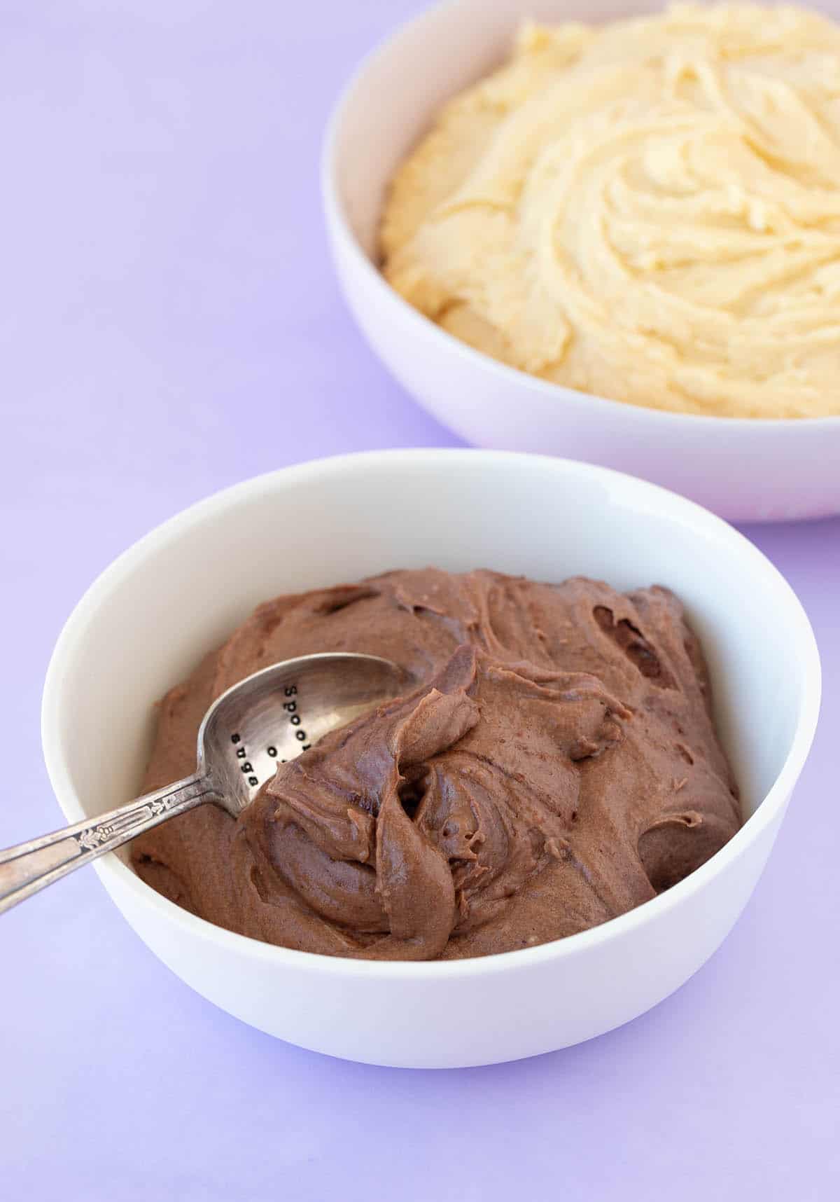 Two bowls of chocolate and vanilla cake batter.